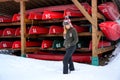 Casual woman standing in front of a kayak rack where kayaks and canoes are docking on rack during the Canadian winter Royalty Free Stock Photo