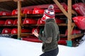 Casual woman standing in front of a kayak rack where kayaks and canoes are docking on rack during the Canadian winter Royalty Free Stock Photo