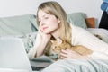 Casual woman using laptop with her red cat in  bedroom. life with pet. shadows Royalty Free Stock Photo