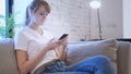 Casual Woman Using Smartphone in Creative Office Royalty Free Stock Photo