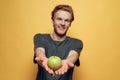 Casual Young Bearded Man Holding Green Apple Royalty Free Stock Photo