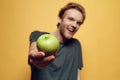 Casual Young Bearded Man Holding Green Apple. Royalty Free Stock Photo