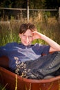 Casual young boy in a wheelbarrow Royalty Free Stock Photo