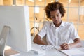 Casual young businessman writing at his desk Royalty Free Stock Photo