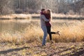 couple standing at lake kissing and embracing each other Royalty Free Stock Photo