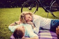 Couple relaxing on a lawn after bike riding. Royalty Free Stock Photo