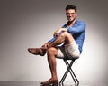 Casual young fashion man sitting with his legs crossed Royalty Free Stock Photo