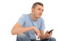 Casual young man with cell phone and headphones Royalty Free Stock Photo
