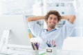 Casual young man with computer in a bright office Royalty Free Stock Photo