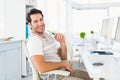 Casual young man with computer in a bright office Royalty Free Stock Photo