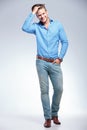 Casual young man with hand in pocket and in hair Royalty Free Stock Photo