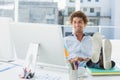 Casual young man with legs on desk in bright office Royalty Free Stock Photo