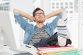 Casual young man with legs on desk in office Royalty Free Stock Photo