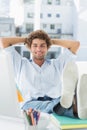 Casual young man with legs on desk in office Royalty Free Stock Photo