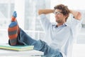 Casual young man with legs on desk in office Royalty Free Stock Photo