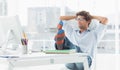 Casual young man with legs on desk in office Royalty Free Stock Photo