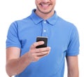 Casual young man plays on his phone Royalty Free Stock Photo