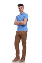 Casual young man in polo shirt standing with hands crossed Royalty Free Stock Photo