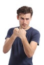 Casual young man ready to fight attacking with fist up