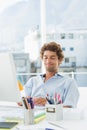 Casual young man using computer in bright office Royalty Free Stock Photo