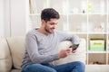 Casual young man using a tablet at home Royalty Free Stock Photo