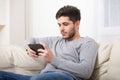 Casual young man using a tablet at home Royalty Free Stock Photo