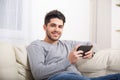 Casual young man using a tablet at home Royalty Free Stock Photo
