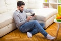 Casual young man using a tablet at home Royalty Free Stock Photo