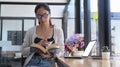 Young woman reading book in modern coffee shop. Royalty Free Stock Photo