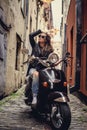 Casual young woman sitting on moto scooter.