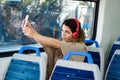 Young woman taking a selfie on train with her phone Royalty Free Stock Photo