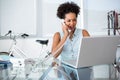 Casual young woman using telephone and laptop Royalty Free Stock Photo