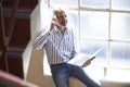 Casually Dressed Businessman Working On Stairs In Office Royalty Free Stock Photo