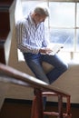 Casually Dressed Businessman Working On Stairs In Office Royalty Free Stock Photo