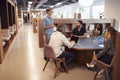 Casually Dressed Businessmen And Businesswomen Having Informal Meeting In Modern Office