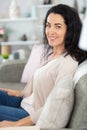 casually dressed middle-aged woman sitting on sofa Royalty Free Stock Photo