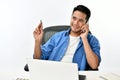 Startup business man smiling while talking on the phone and having fun at work Royalty Free Stock Photo