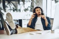 Casually dressed young businessman using mobile phone in office Royalty Free Stock Photo