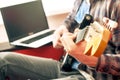 Casually dressed young man with guitar playing songs in the room at home. Online guitar lessons concept. Male guitarist practicing Royalty Free Stock Photo