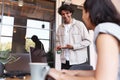 Young couple with laptops at desks preparing for online meeting in rented open plan office space Royalty Free Stock Photo