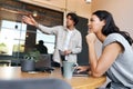 Young couple with laptops at desks preparing for online meeting in rented open plan office space Royalty Free Stock Photo