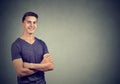 Casually handsome confident young man in t-shirt keeping arms crossed Royalty Free Stock Photo