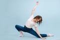 Casualy dressed contemporary dancer in a low lunge, body twisted back Royalty Free Stock Photo