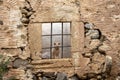 Cat in Abandoned Stone Window, Rustic Wall, Solitude and Curiosity Royalty Free Stock Photo