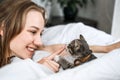 Cat Adoption, Adopt kitten from rescues and shelters. Rehome a Cat. Portrait of woman playing with outbred homeless Royalty Free Stock Photo