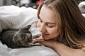 Cat Adoption, Adopt kitten from rescues and shelters. Rehome a Cat. Portrait of woman playing with outbred homeless Royalty Free Stock Photo