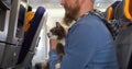 Cat in the aircraft cabin sitting in hands of owner during the flight, concept of travelling and moving with pets