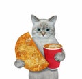 Cat ashen holds fried pie and cup of coffee