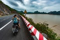 Exploring Vietnam Cat Ba Island Girl Backpacker on a Scooter looks at Ha long Bay