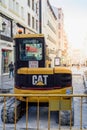 CAT backhoe working on public works on the street in central Madrid